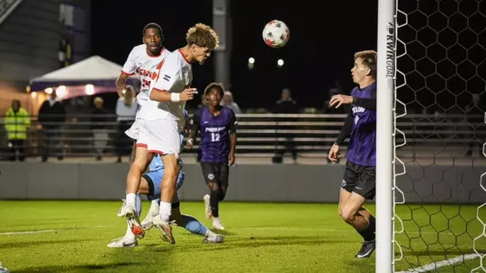 Erik Collins heads a goal in at Portland.