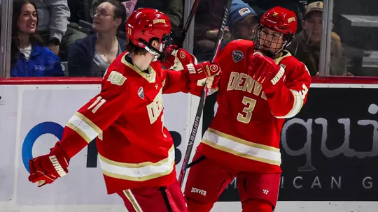 Denver hockey players Cale Aschroft and Daxon Rudolph celebrate on October 2, 2026 during the game at Alaska Anchorage.