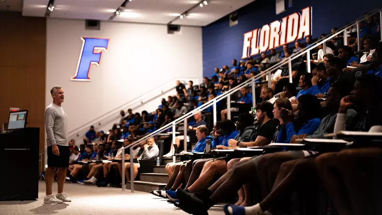 Billy Donovan speaks to football team