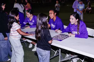 logan and kaela signing autographs fro youth teams