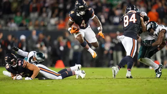 CHICAGO, ILLINOIS - SEPTEMBER 28: D'Andre Swift #4 of the Chicago Bears leaps with the ball during the fourth quarter of the NFL game against the Philadelphia Eagles at Soldier Field on September 28, 2026 in Chicago, Illinois. (Photo by Todd Rosenberg/Getty Images)