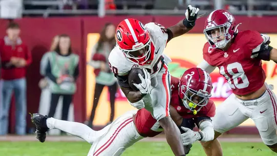 Georgia running back Dwight Phillips Jr. tries to avoid the tackle attempt of Alabama defensive back Zabien Brown