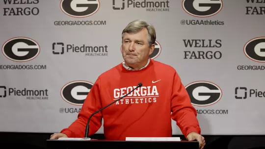 Coach Smart at Press Conference standing at podium