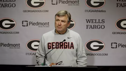 Coach Smart standing at Podium at Press Conference