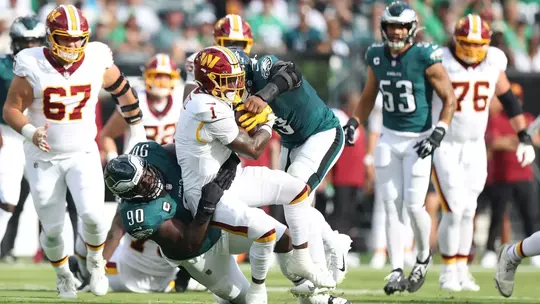 PHILADELPHIA, PENNSYLVANIA - SEPTEMBER 13: Jordan Davis #90 and Nolan Smith Jr. #3 of the Philadelphia Eagles tackle Rachaad White #1 of the Washington Commanders in the first quarter of a game at Lincoln Financial Field on September 13, 2026 in Philadelphia, Pennsylvania. (Photo by Emilee Chinn/Getty Images)