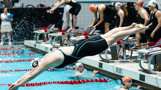 A Georgia women's swimmer enters the pool during a race against Tennessee on Jan. 23, 2026.