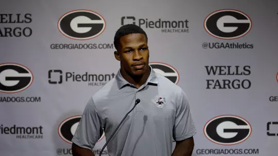Kyron Jones standing at podium for Football Media Day Press Conference