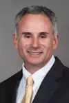 Assistant Coach John Loose headshot with a suit and tie on.