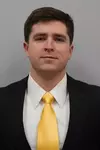 Panker Assistant Coach with a suit and tie on.