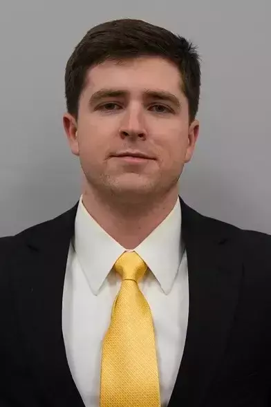 Panker Assistant Coach with a suit and tie on.