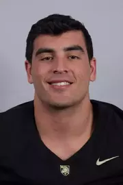 Andon Thomas headshot with a Black Army Football jersey on.
