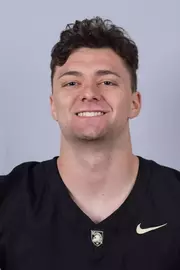 Christian Yousefzadeh headshot with a Black Army Football jersey on.