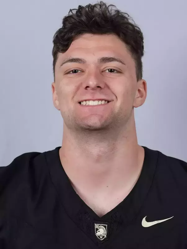 Christian Yousefzadeh headshot with a Black Army Football jersey on.