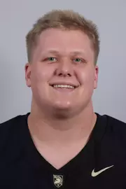 Chuck Johnson headshot with a Black Army Football jersey on.