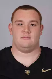 Kyle Baltazar headshot with a Black Army Football jersey on.