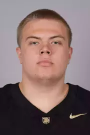 Tim Savchuk headshot with a Black Army Football jersey on.