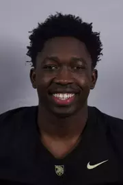 Tobi Olawole headshot with a Black Army Football jersey on.