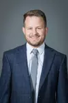 Troy Nickerson Headshot with a suit and tie on.