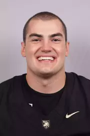 Ben Komopka headshot with a Black Army Football jersey on.