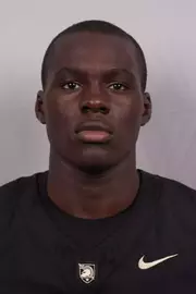Andrew Afolabi headshot with a Black Army Football jersey on.