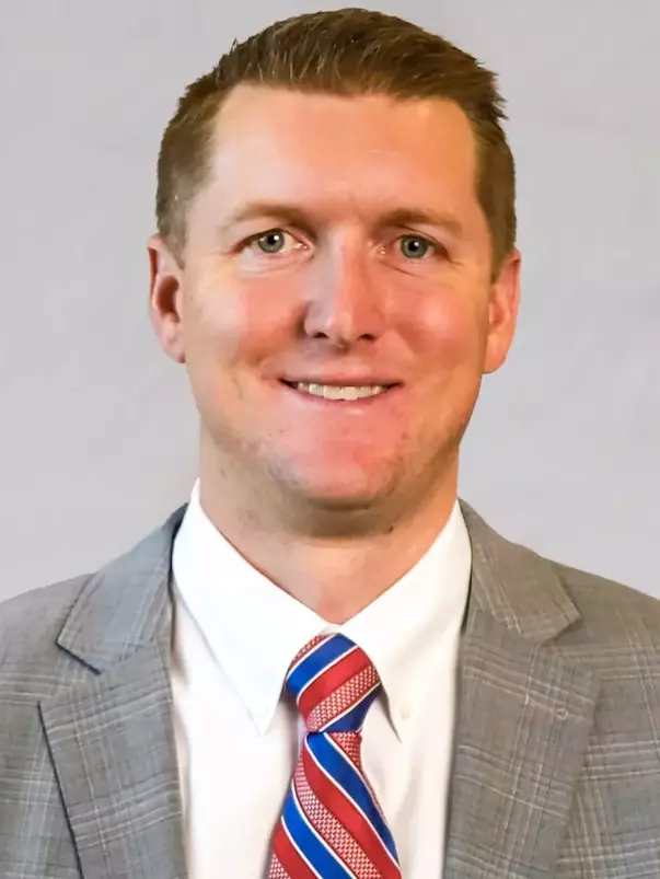 Rick Lewis Headshot with a suit and tie on.