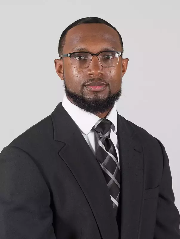 Munir Prince Headshot with a suit and tie on.