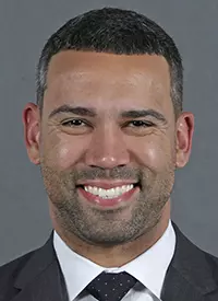 This is a head shot of Director of Men's Basketball Operations Kahil Fennell, wearing a dark suit and tie.