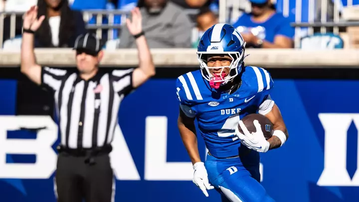 Duke wide receiver Jaivon Solomon, wearing a blue helmet, blue shirt and blue pants, smiles and celebrates his touchdown scored in Duke's 62-7 victory against William & Mary.