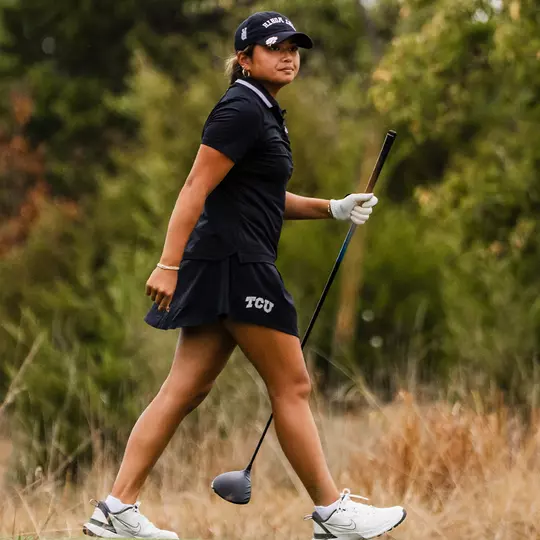Kirstin Angosta departs the tee box holding her driver shaft as she tracks her ball