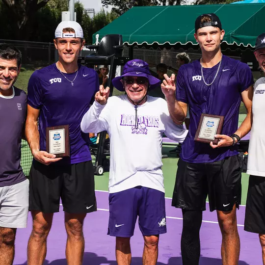 Albert Pedrico and Cooper Woestendick celebrate their ITA Texas Regional doubles championship with the coaching staff