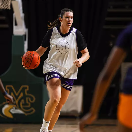 Lara Somfai dribbles in transition wearing a white practice jersey
