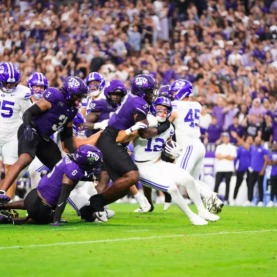 TCU's defense swarms the BYU runner.