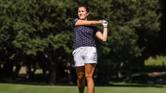 Ella Forss plays a second shot with an iron wearing a black shirt