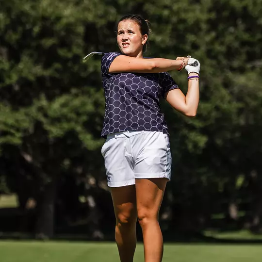 Ella Forss plays a second shot with an iron wearing a black shirt
