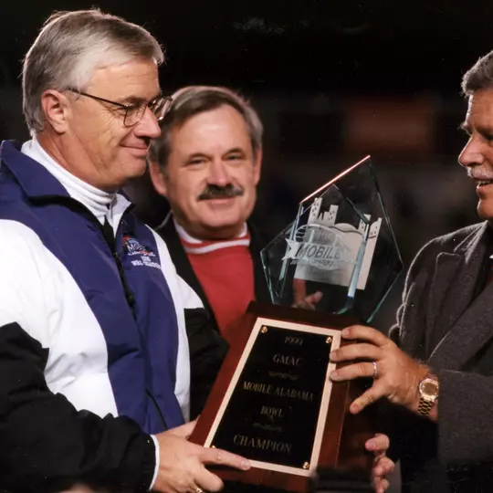 Dennis Franchione receives the 1999 GMAC Bowl Trophy.