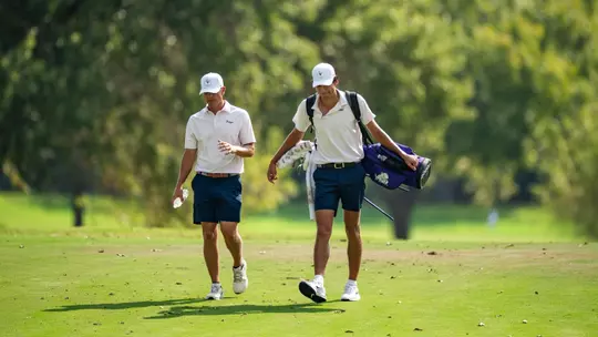Bill Allcorn and Sam Udovich walk down the fairway at Colonial Country Club.