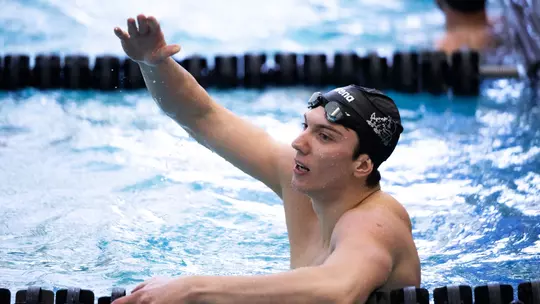 Edgar Cicanci going to high five another swimmer in the pool