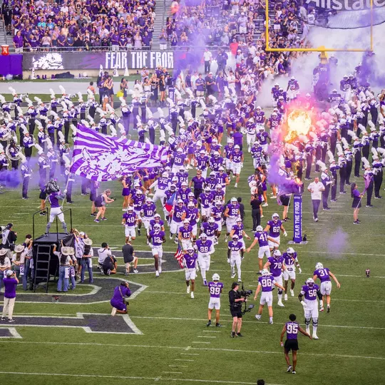 TCU football team running out of the tunnel before its game against Abilene Christian