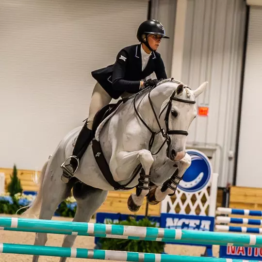 Lex Lipacis jumping over a fence at the NCEA Championships