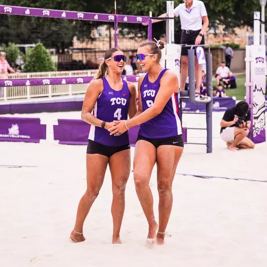 Grace Townson and Olivia Clines embracing on a beach volleyball court