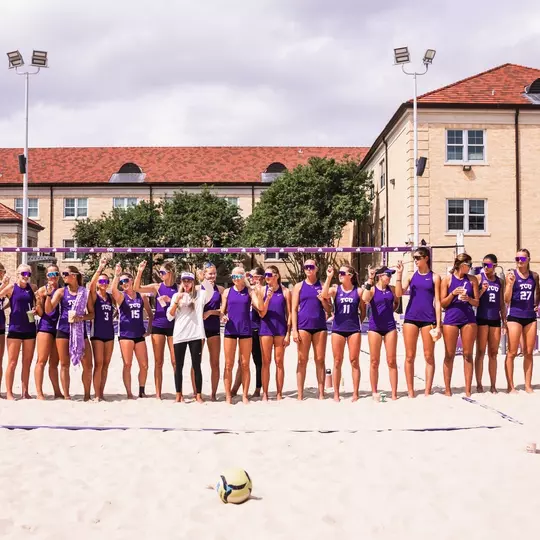 TCU beach volleyball team in a line postgame