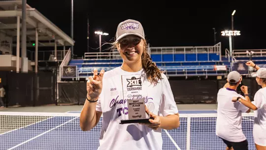 Jennifer Jackson holding Big 12 Tournament Most Outstanding Player Trophy