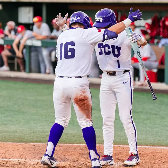 Nolan Traeger and Jack Bell knock helmets at home plate after Traeger's home run in the sixth.