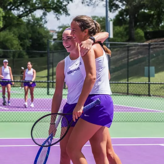 Raquel Caballero Chica and Jennifer Jackson smiling and hugging each other