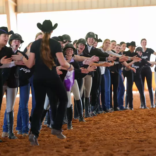 TCU equestrian team celebrating an MOP after the meet