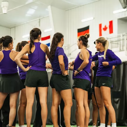 TCU women's tennis team huddling on court at the LSU Tennis center