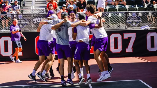 The TCU men's tennis team celebrates after clinching a 4-3 victory over Ohio State.