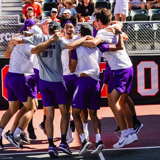 The TCU men's tennis team celebrates after clinching a 4-3 victory over Ohio State.