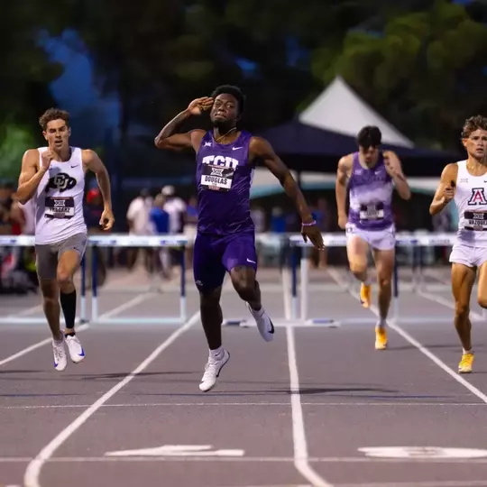 TCU track's Jayden Douglas celebrates as he crosses the finish line in the 400m hurdles