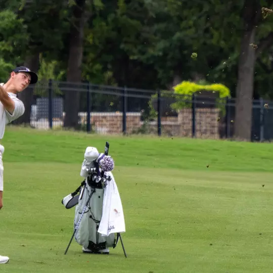 Nathan Miller follows through after an iron shot in the fairway.